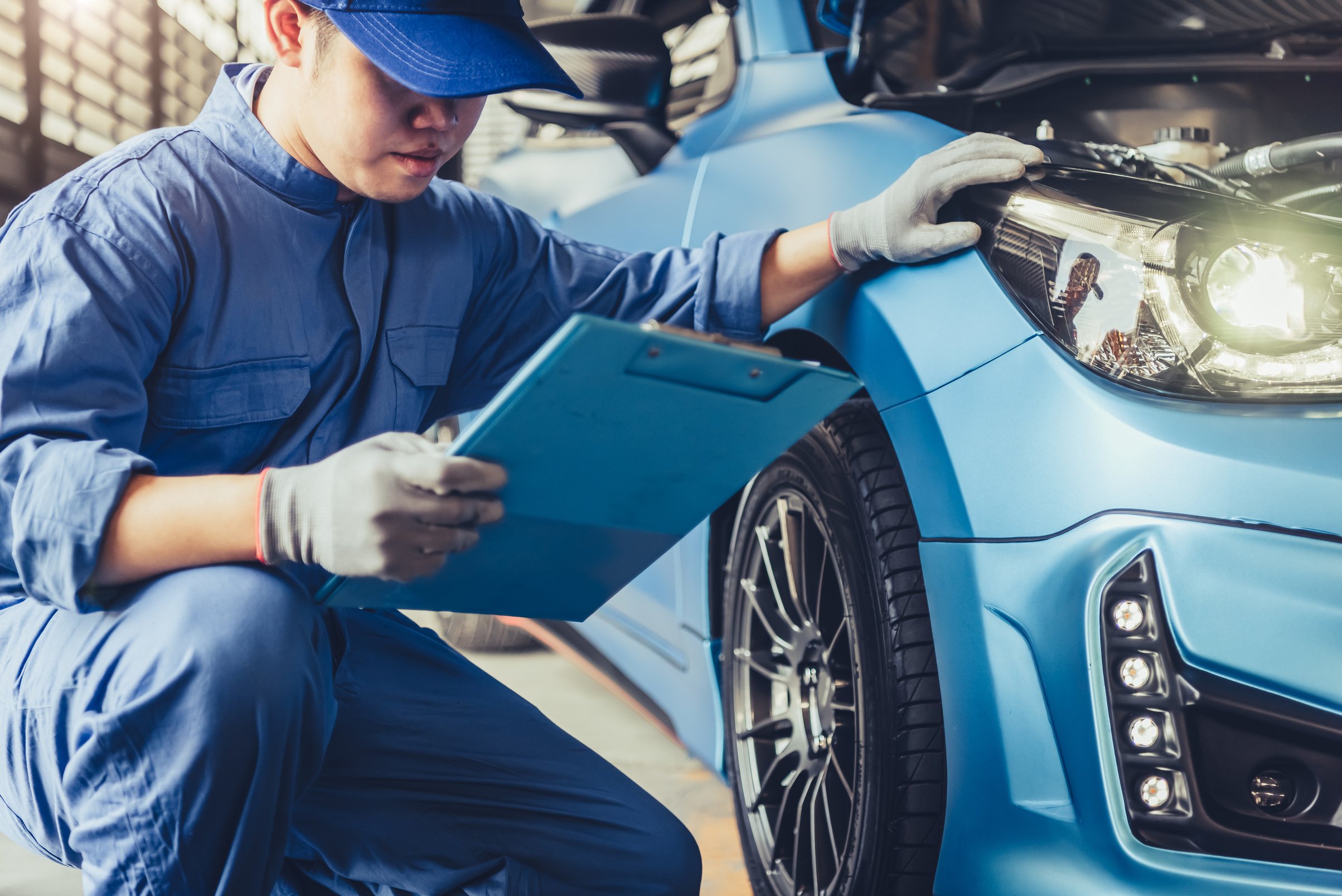 Asian Car Mechanic Technician Holding Clipboard 