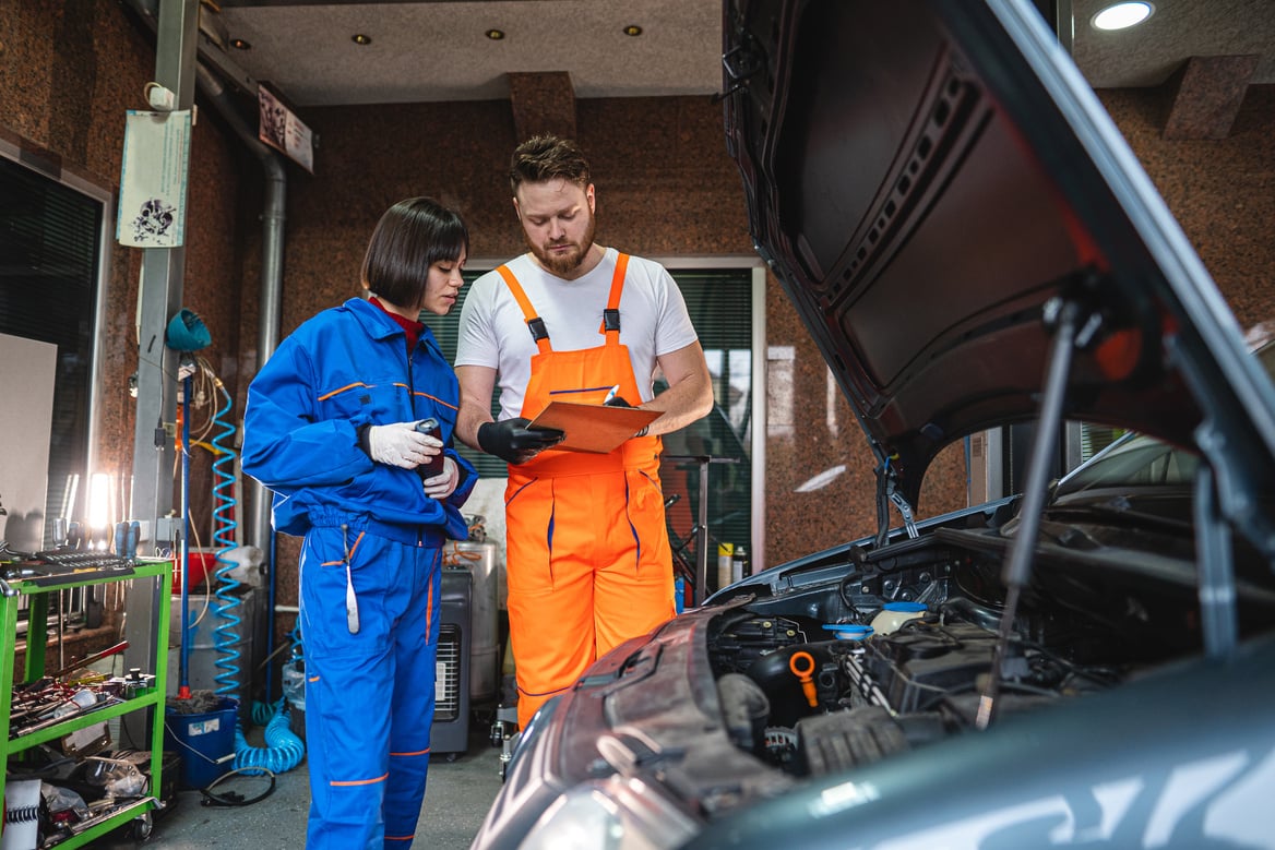 Technicians inspecting a car